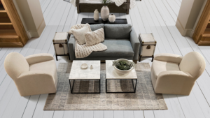 Neutral, modern living room with cozy textures and minimalist staging—perfect example of home staging that attracts Colorado buyers.