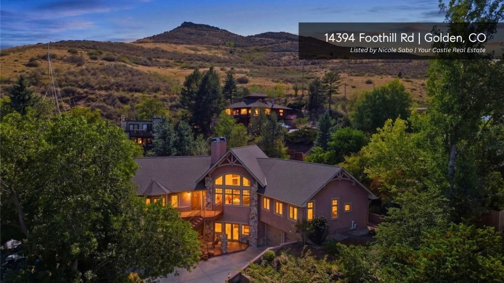 Custom home at 14394 Foothill Road in Golden, Colorado, surrounded by mature trees and foothill scenery.