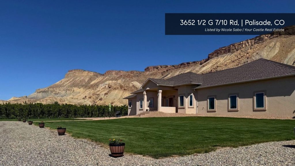 Acreage home at 3652 1/2 G 7/10 Road in Palisade, Colorado, beneath the dramatic cliffs of Mount Garfield.